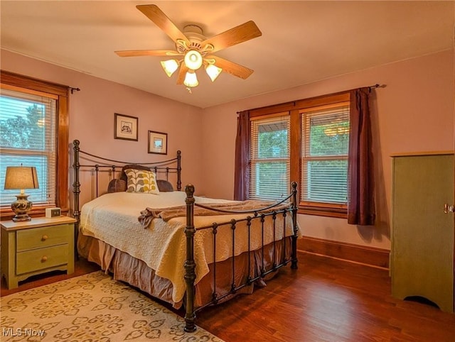 414 W Maple St, Hartville, OH 44632 - bedroom with multiple windows, wood finished floors, and ceiling fan