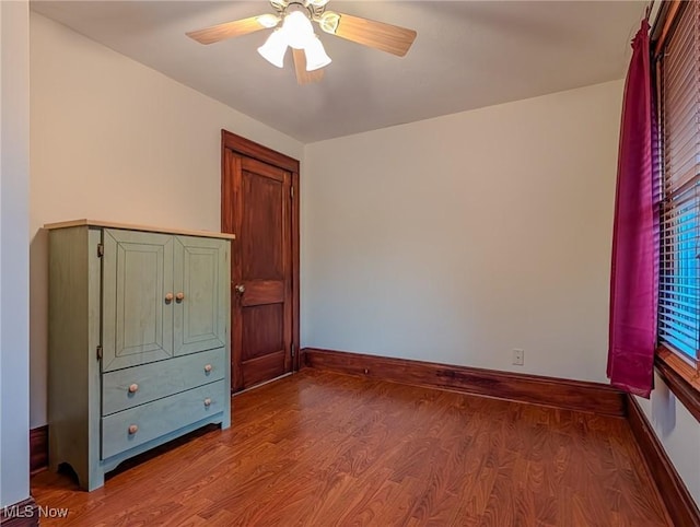 414 W Maple St, Hartville, OH 44632 - unfurnished bedroom featuring wood finished floors and a ceiling fan