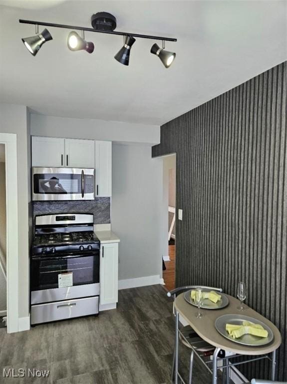 21731 Nicholas Ave, Euclid, OH 44123 - kitchen with appliances with stainless steel finishes, white cabinetry, dark wood finished floors, light countertops, and wallpapered walls