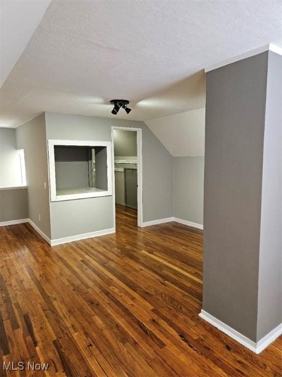 21731 Nicholas Ave, Euclid, OH 44123 - additional living space with a textured ceiling, wood finished floors, and vaulted ceiling