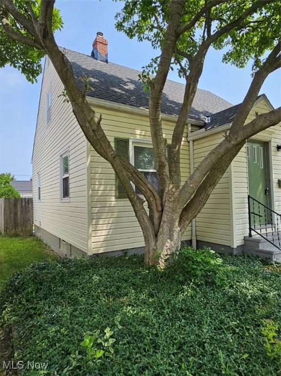 21731 Nicholas Ave, Euclid, OH 44123 - view of side of home featuring a shingled roof and a chimney