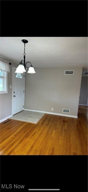 132 Highland Acres, Bloomingdale, OH 43910 - unfurnished dining area featuring light wood-style floors and a chandelier