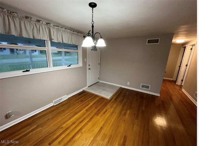 132 Highland Acres, Bloomingdale, OH 43910 - unfurnished dining area featuring wood finished floors and a chandelier