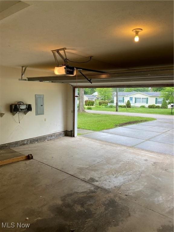 4920 Thomas Blvd, Geneva, OH 44041 - garage featuring electric panel and a garage door opener