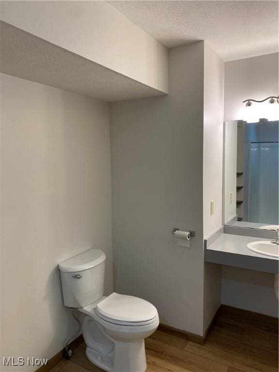 4920 Thomas Blvd, Geneva, OH 44041 - half bath with wood finished floors, a textured ceiling, and vanity