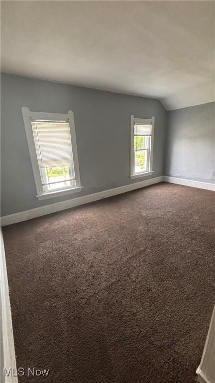 1682 E 33rd St, Lorain, OH 44055 - carpeted spare room featuring vaulted ceiling and baseboards