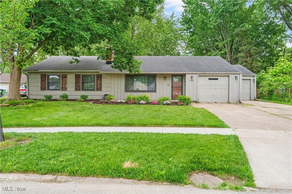 455 Lynn Dr, Berea, OH 44017 - single story home with concrete driveway, a garage, a front yard, and board and batten siding