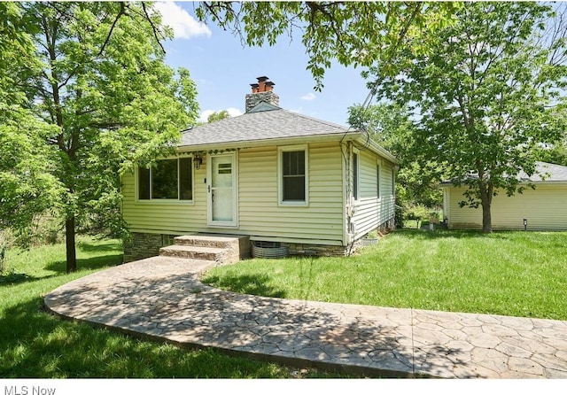 3371 Brecksville Rd, Richfield, OH 44286 - bungalow-style home featuring a chimney, a front yard, and a shingled roof