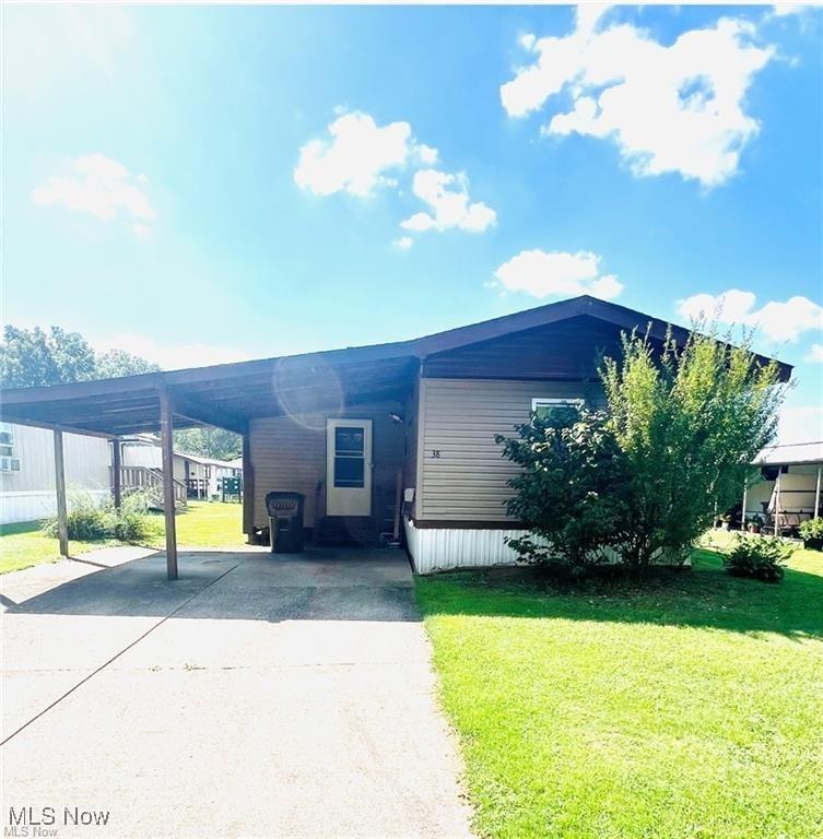 38 Carroll Ave, Orwell, OH 44076 - manufactured / mobile home featuring driveway, an attached carport, and a front yard