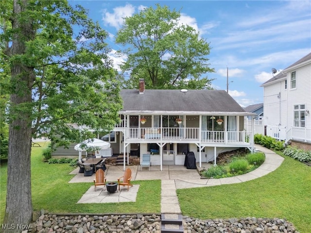 4324 Ormond Dr, New Franklin, OH 44319 - rear view of property featuring a patio, a chimney, an outdoor fire pit, a deck, and a lawn
