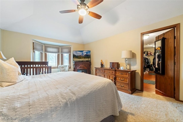 7700 Sparrow Flight Dr, Seven Hills, OH 44131 - carpeted bedroom with a walk in closet, ceiling fan, lofted ceiling, and a closet