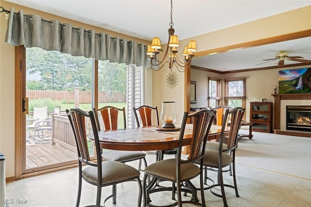 7700 Sparrow Flight Dr, Seven Hills, OH 44131 - dining room with crown molding, a chandelier, a glass covered fireplace, and ceiling fan