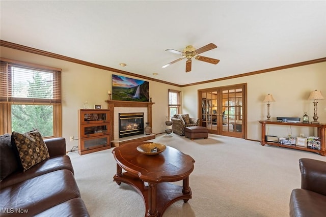 7700 Sparrow Flight Dr, Seven Hills, OH 44131 - carpeted living room featuring a ceiling fan, healthy amount of natural light, french doors, a glass covered fireplace, and crown molding