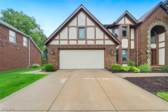 7700 Sparrow Flight Dr, Seven Hills, OH 44131 - tudor house featuring brick siding, stucco siding, concrete driveway, and a front yard