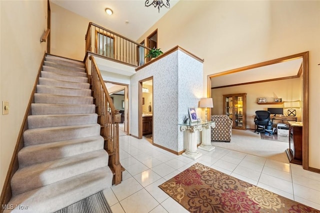 7700 Sparrow Flight Dr, Seven Hills, OH 44131 - stairs featuring a high ceiling, tile patterned flooring, and carpet