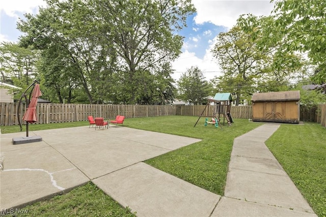 4938 N Sedgewick Rd, Lyndhurst, OH 44124 - fenced backyard with a patio, a storage shed, and a playground
