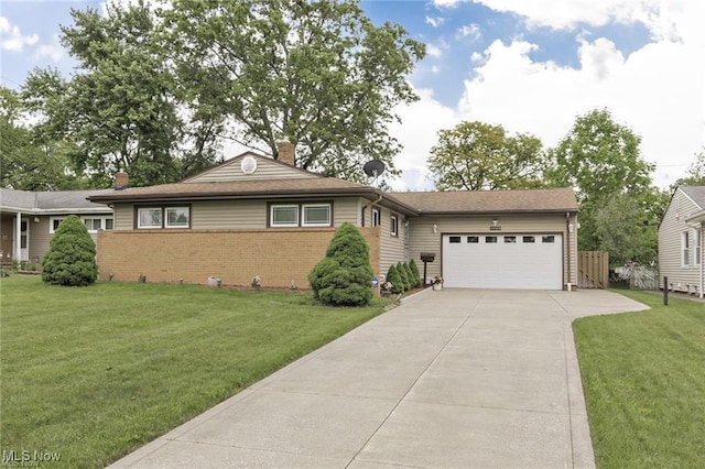 4938 N Sedgewick Rd, Lyndhurst, OH 44124 - view of front of home featuring concrete driveway, a garage, a chimney, brick siding, and a front lawn