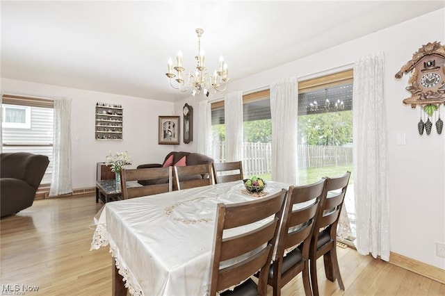 4938 N Sedgewick Rd, Lyndhurst, OH 44124 - dining room featuring a chandelier, light wood-style floors, and plenty of natural light