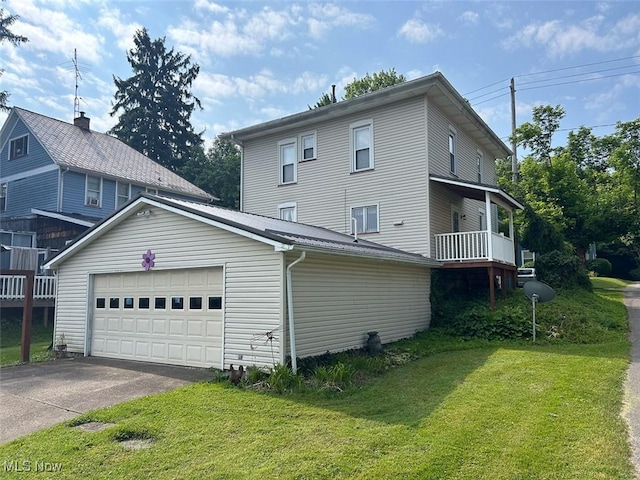 330 E Main St, East Palestine, OH 44413 - view of home's exterior featuring a lawn, asphalt driveway, and a garage