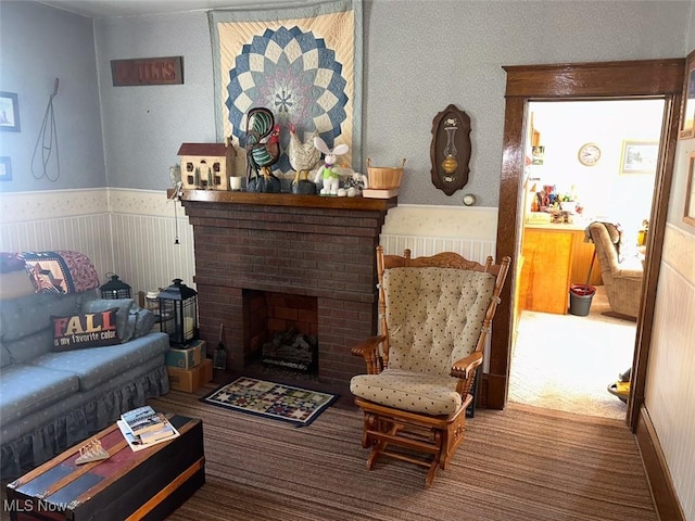 330 E Main St, East Palestine, OH 44413 - living area featuring carpet flooring, a fireplace, and a wainscoted wall