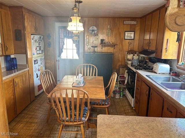 330 E Main St, East Palestine, OH 44413 - dining room featuring brick patterned floors, a chandelier, and wood walls