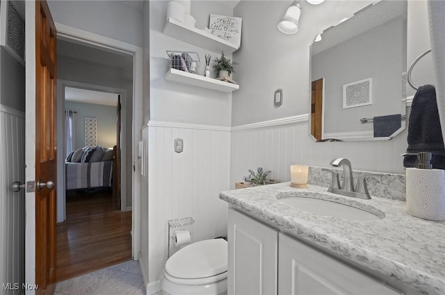 5910 Gerald Ave, Parma, OH 44129 - ensuite bathroom featuring vanity and a wainscoted wall