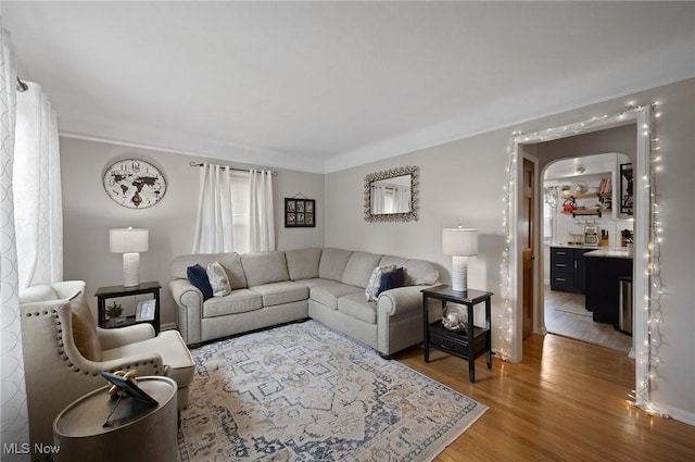 5910 Gerald Ave, Parma, OH 44129 - living area featuring light wood-style floors, ornamental molding, and arched walkways