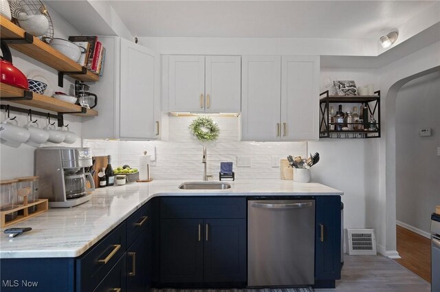 5910 Gerald Ave, Parma, OH 44129 - kitchen featuring dishwasher, blue cabinetry, open shelves, tasteful backsplash, and white cabinetry