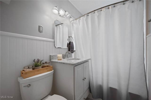 5910 Gerald Ave, Parma, OH 44129 - bathroom featuring vanity, a shower with curtain, and wainscoting