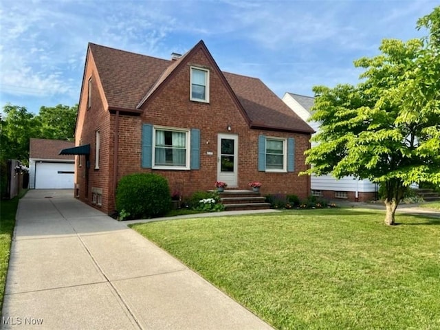 5910 Gerald Ave, Parma, OH 44129 - view of front of home with brick siding, an outbuilding, a front yard, and a garage