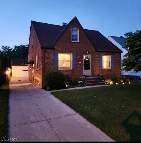 5910 Gerald Ave, Parma, OH 44129 - view of front facade with brick siding, concrete driveway, an outdoor structure, and a front lawn