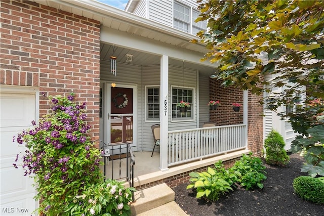 637 N Ridgecliff St, Tallmadge, OH 44278 - entrance to property featuring covered porch and brick siding