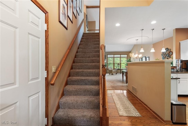 637 N Ridgecliff St, Tallmadge, OH 44278 - stairs with wood finished floors, a chandelier, and recessed lighting