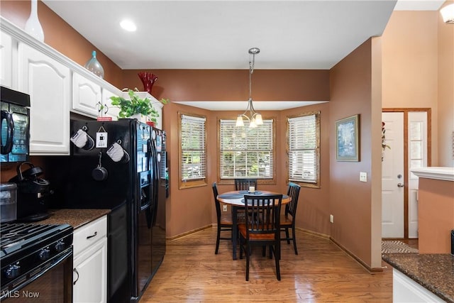 637 N Ridgecliff St, Tallmadge, OH 44278 - kitchen with black appliances, white cabinetry, light wood-type flooring, pendant lighting, and a chandelier