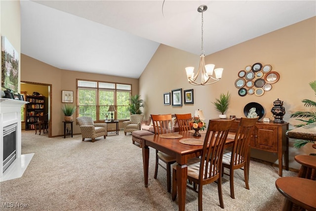 637 N Ridgecliff St, Tallmadge, OH 44278 - dining room featuring light colored carpet, a chandelier, a fireplace with flush hearth, and high vaulted ceiling