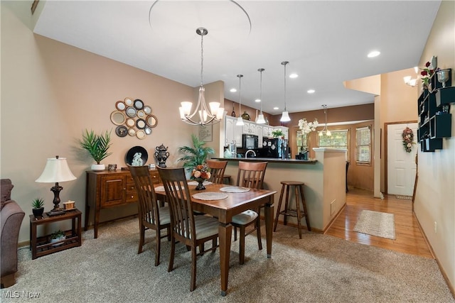 637 N Ridgecliff St, Tallmadge, OH 44278 - dining area with a chandelier, light colored carpet, recessed lighting, and light wood-style flooring