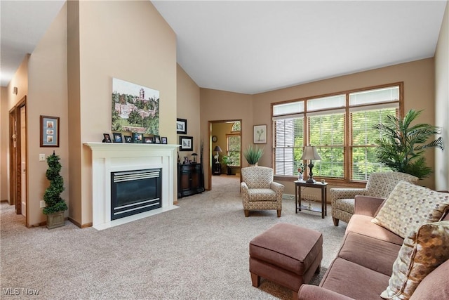 637 N Ridgecliff St, Tallmadge, OH 44278 - living room featuring carpet flooring, a fireplace with flush hearth, and high vaulted ceiling