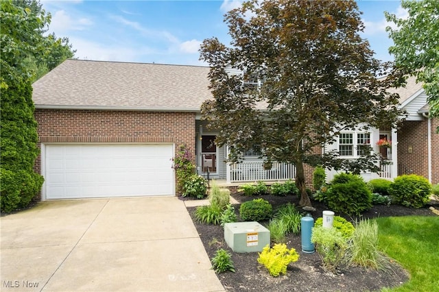 637 N Ridgecliff St, Tallmadge, OH 44278 - obstructed view of property featuring brick siding, a shingled roof, driveway, and a porch