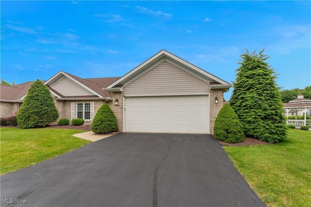 7876 Walnut St Unit B, Boardman, OH 44512 - single story home with driveway, brick siding, a garage, and a front lawn