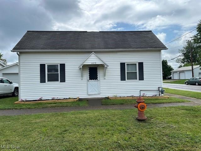 423 S 7th St, Cambridge, OH 43725 - view of front of home with a front yard and roof with shingles