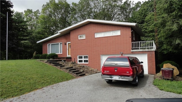 3981 Washington School Rd, New Cumberland, WV 26047 - tri-level home featuring asphalt driveway, brick siding, a garage, and a front lawn