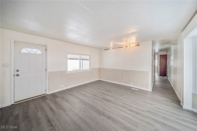 34424 Euclid Ave Unit 260, Willoughby, OH 44094 - entrance foyer with wood finished floors, a textured ceiling, and wainscoting