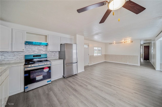 34424 Euclid Ave Unit 260, Willoughby, OH 44094 - kitchen featuring appliances with stainless steel finishes, range hood, light wood-style floors, light countertops, and white cabinetry
