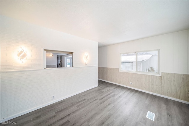 34424 Euclid Ave Unit 260, Willoughby, OH 44094 - spare room featuring wood finished floors and brick wall