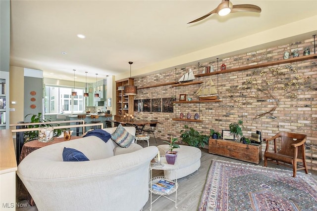 1569 E 118th St Unit B, Cleveland, OH 44106 - living area with brick wall, wood finished floors, and ceiling fan