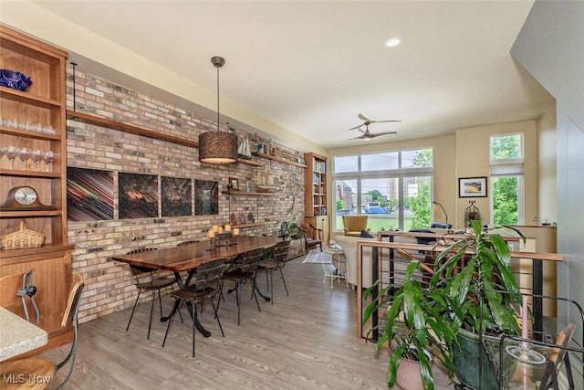 1569 E 118th St Unit B, Cleveland, OH 44106 - dining area featuring brick wall, wood finished floors, and a ceiling fan