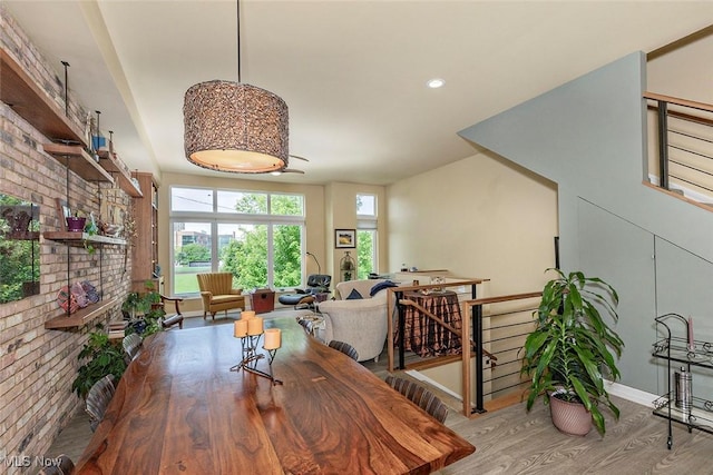 1569 E 118th St Unit B, Cleveland, OH 44106 - dining area with wood finished floors, brick wall, a fireplace, and recessed lighting