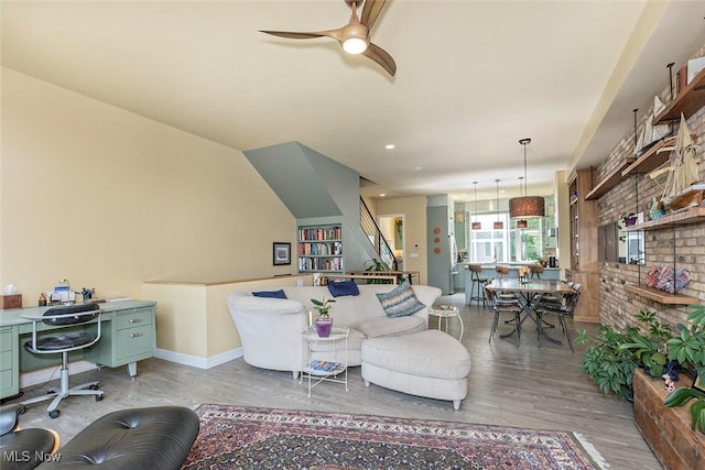 1569 E 118th St Unit B, Cleveland, OH 44106 - living area with light wood-type flooring, a desk, ceiling fan, and stairs