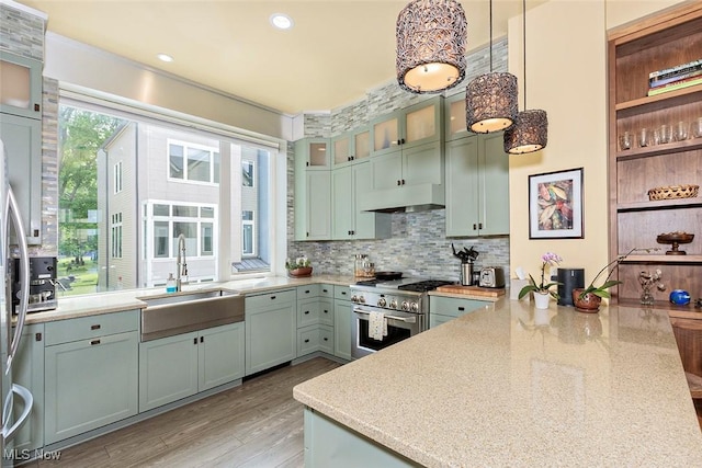 1569 E 118th St Unit B, Cleveland, OH 44106 - kitchen featuring high end stainless steel range oven, white dishwasher, under cabinet range hood, tasteful backsplash, and light wood finished floors