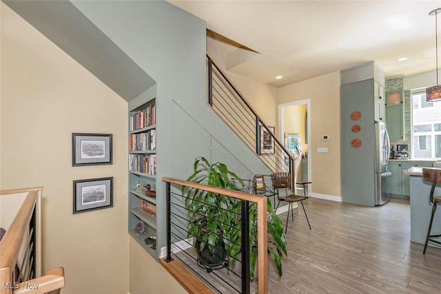 1569 E 118th St Unit B, Cleveland, OH 44106 - hallway with light wood-style flooring, stairs, built in features, and recessed lighting